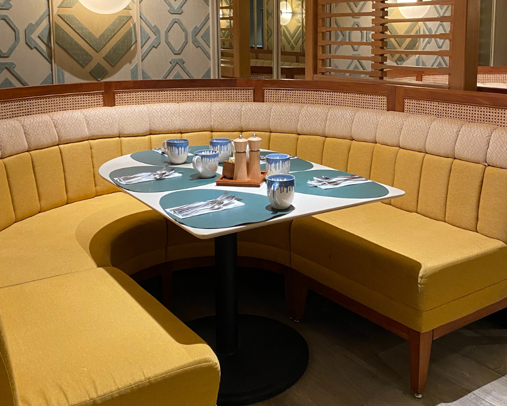 Banquette de restaurant en tissu jaune dans une salle élégante – Les astuces de Max par Maison Max Clean